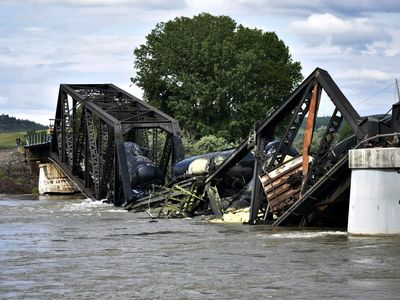 A train carrying hazardous materials plunges into Yellowstone River after bridge fails
