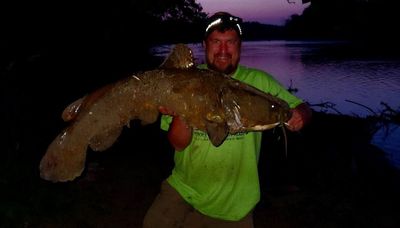 Battling a personal-best flathead out of a log jam