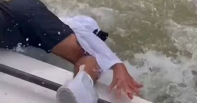 Terrifying moment shark bites an unsuspecting fisherman's hand and drags him overboard
