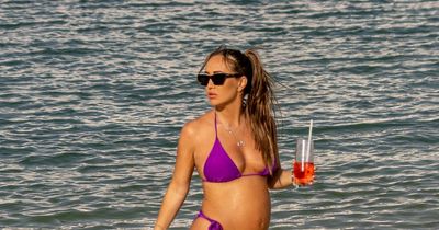 Pregnant Lauryn Goodman dons 'KW' necklace with bikini after Anne Kilner row