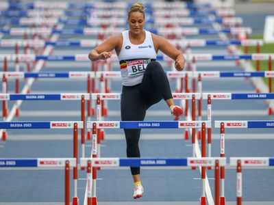 A Belgian shot-putter hops over hurdles after answering her team's call for help