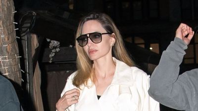 Angelina Jolie's white trench coat is pure sophistication, but we've got our eye on her ivory Valentino bag