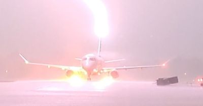 Spectacular moment lightning strikes plane full of passengers on runway