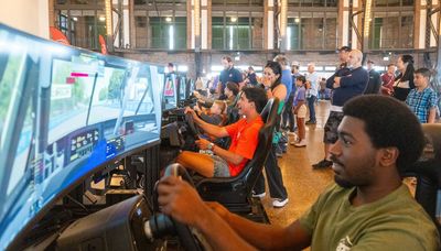 Fans take the wheel on a simulator of Chicago’s NASCAR course at Navy Pier