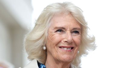 Queen Camilla embraces luxury fashion with timeless trench coat and intriguing blue dress