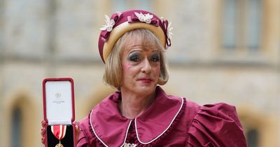 Grayson Perry receives knighthood at Windsor Castle in striking 'grandmother of the bride' burgundy dress