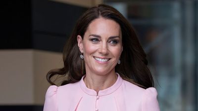 Princess Catherine gives a nod to the 80s with her bright white heels as she pairs the retro shoe choice with dainty pink button-down dress