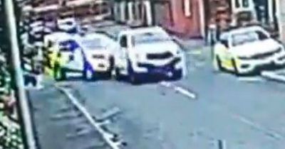 Moment driver 'rams' into police car before speeding off leaving two officers injured