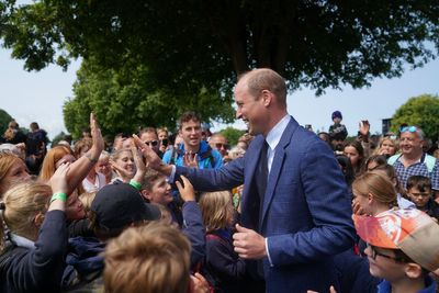 Prince of Wales high-fives children and presents goat trophy on visit to show