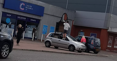 Scots shoppers baffled as man straps massive chest of drawers and mirror to car roof