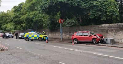 Edinburgh police race to rush hour crash on busy street as car mounts pavement