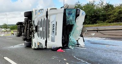 Motorway closed in both directions all day after milk tanker overturns