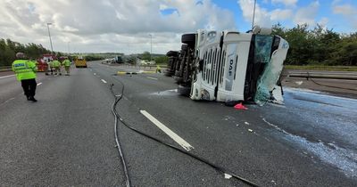 Drivers stuck for HOURS after huge tanker overturns and spills 20,000 litres of milk all over M6