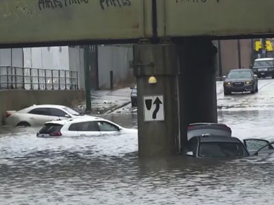 Heavy rains flood Chicago roads and force a downtown street race to be cut short