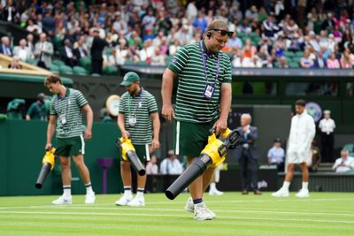 Leaf blowers used to dry Centre Court surface during Novak Djokovic match