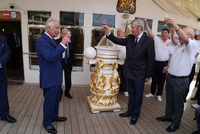 King enjoys tot of rum with former Royal Yacht Britannia sailors