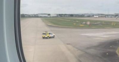 Passenger aircraft surrounded by fire engines in dramatic airport incident