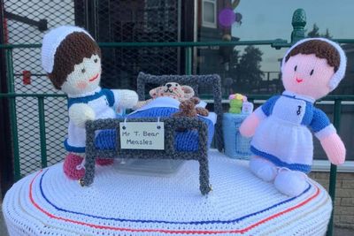 Knitting group create postbox topper and 75 baby hats for NHS 75th anniversary