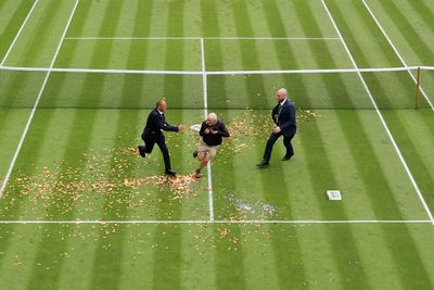 Wimbledon ‘Just Stop Oil’ protestors spill orange confetti all over courts