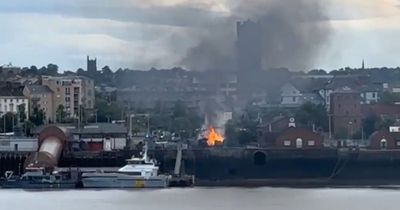 Flames and smoke seen from across River Mersey