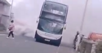 Bus catches fire with smoke billowing out on residential Scottish street