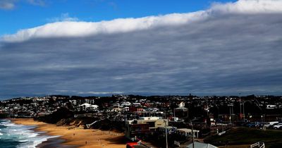 Watch this strange and spectacular cloud roll over Newcastle Beach