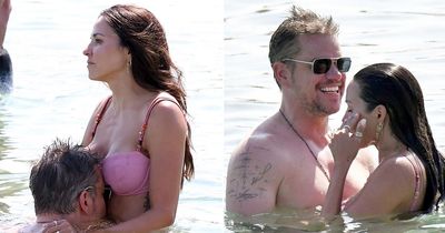 Matt Damon puts his head between bikini-clad wife's boobs in racy beach display