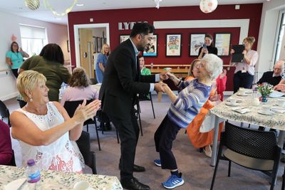 Humza Yousaf dances and chats with care home residents