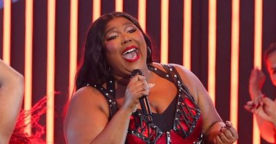 Lizzo removes skirt on-stage as she wows crowd in lace-up black leather bodysuit