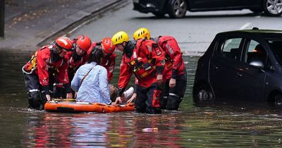 Woman pulled from car after flash floods hit Merseyside