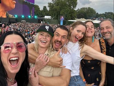 Chelsea Handler serves drinks for Orlando Bloom and Katy Perry at Bruce Springsteen show
