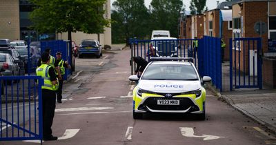 Crowd of 100 people gather as male teacher 'stabbed' at school and teenager arrested