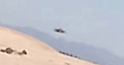 Tourist accidentally captures floating 'UFO' while taking selfie at sand dunes
