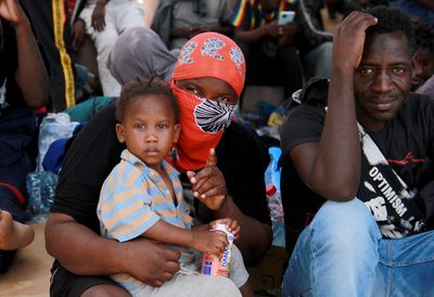 Under pressure, Tunisia takes back hundreds of migrants trapped in a border zone with Libya