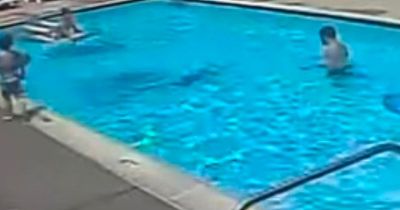 Chilling moment adults swim past boy, 7, as he drowns in apartment swimming pool