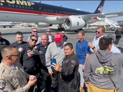 Blowback after Trump seen taking selfies with police officers