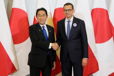 Japan's leader holds security, business talks in Poland on his way to NATO summit