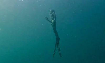 Watch: Surfacing diver dodges passing boat in close call