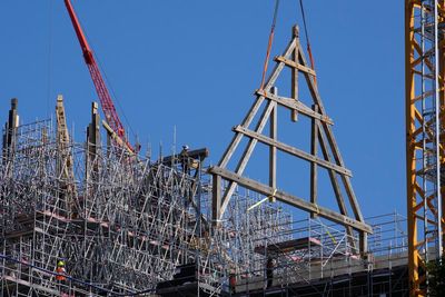Crane at fire-ravaged Notre Dame in Paris hoists giant wood trusses to the cathedral's roof