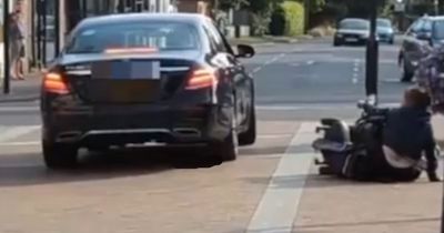 Horror moment Mercedes driver pushes woman off her mobility scooter in road rage row