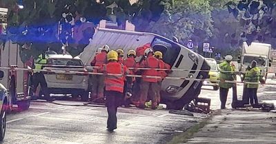 Emergency services swarm street as van flips over in crash with five injured