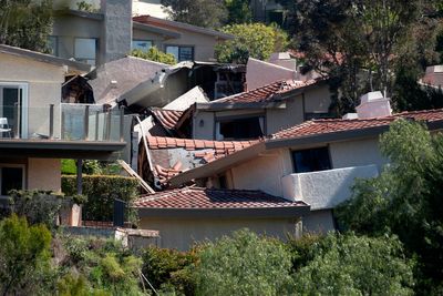 Destructive Southern California landslide slows but more homes ordered evacuated as sewer breaks