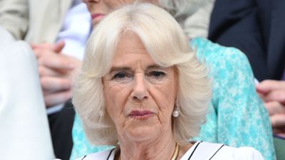 Queen Camilla stuns in striped puffed-sleeve dress and daring gold choker as she makes first Wimbledon appearance since 2019