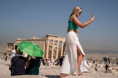 Tourists endure high temperatures at Athens Acropolis as heatwave sweeps through Greece