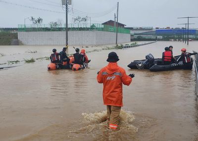 Live: Rescue crews attend scene of flooded South Korea underpass