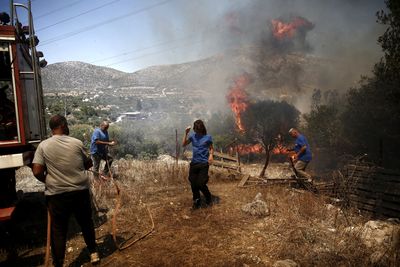 Authorities order evacuations as wildfires rage near Athens