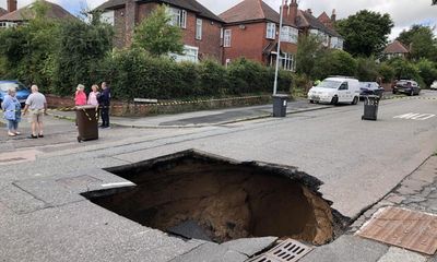 ‘Neighbours are fed up with it’: huge sinkhole closes Greater Manchester street