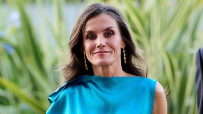 Queen Letizia's colour-blocking look delights as she steps out in luscious silky teal co-ord and impressive gold accessories
