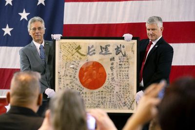 A flag carried by a Japanese soldier who was killed during World War II is returning to his family