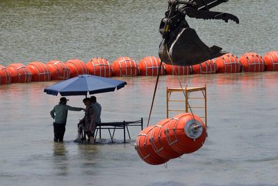 Justice Department tells Texas that floating barrier on Rio Grande raises humanitarian concerns